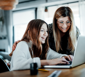 Two people looking at a computer