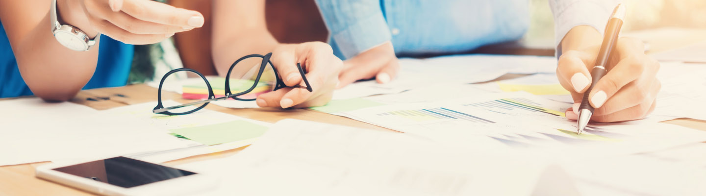 a man and woman looking at paperwork on a desk