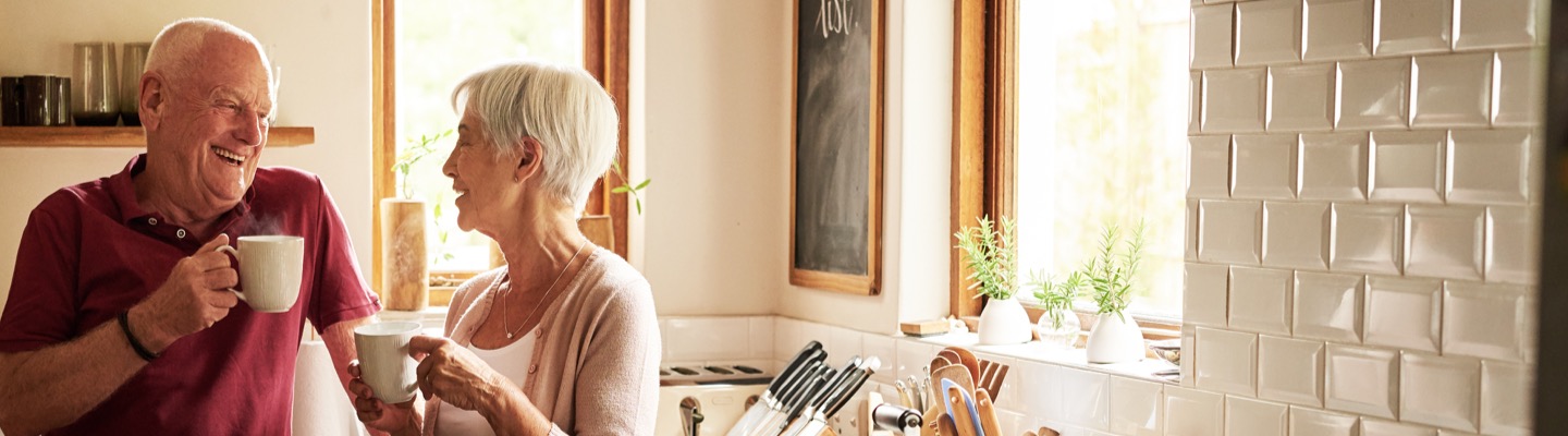 Mature couple with coffee in kitchen