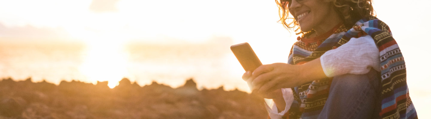 woman looking at phone outside